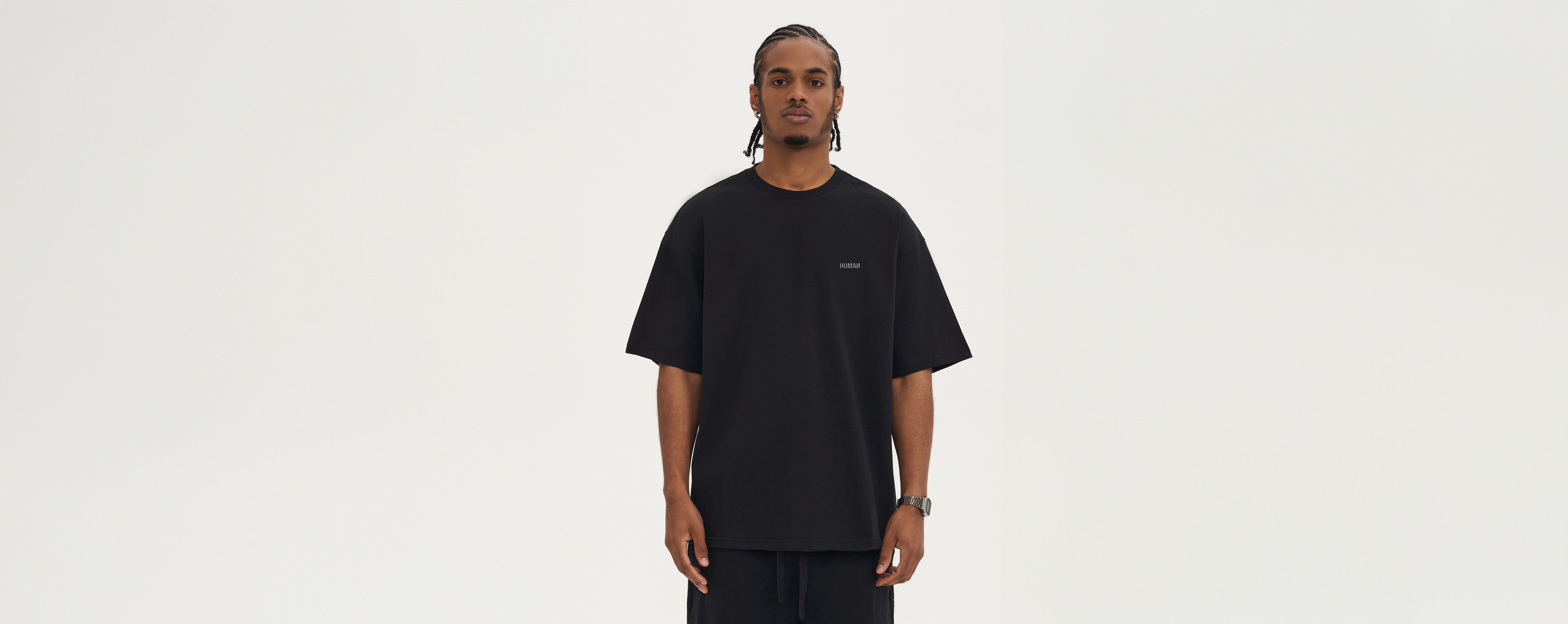 Black male wearing an oversized human of the future t-shirt